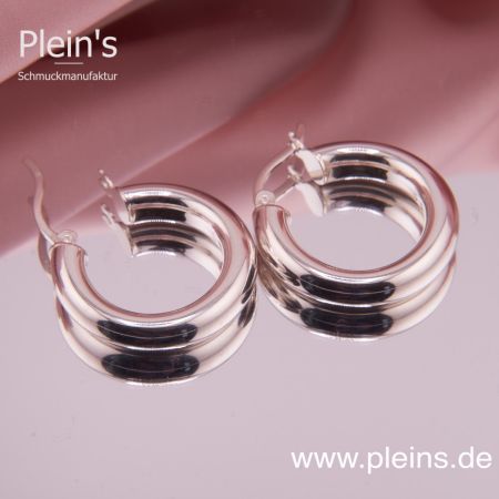 Nahaufnahme der Klappcreolen mit einer geöffneten Creole, liegend auf einer glatten Fläche.